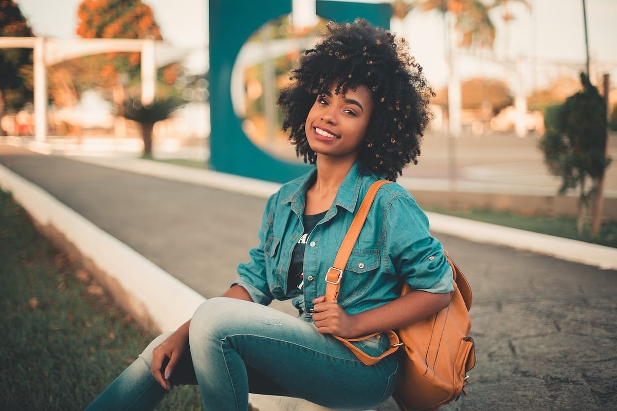 Woman student sitting outdoors on campus
